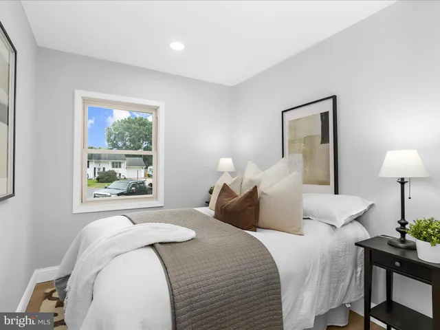 a bedroom with a bed and a lamp