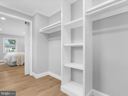 a view of bedroom and bedroom with wooden floor