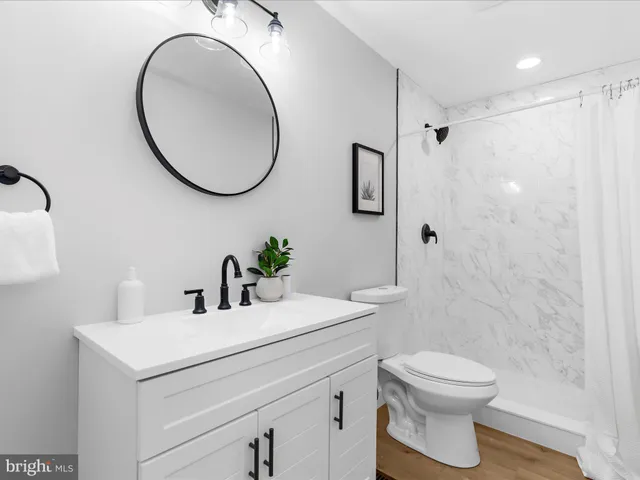 a bathroom with a sink a toilet and a mirror