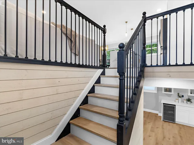 a view of entryway with wooden floor and stairs