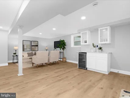 a living room with furniture and a kitchen