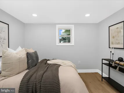 a bedroom with a bed and a desk