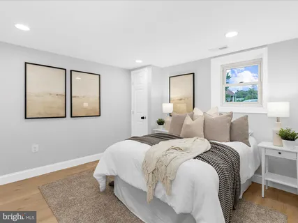 a bed room with a bed and a painting on the wall