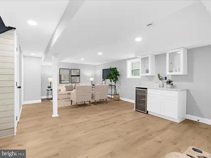 a view of living room kitchen with furniture and a wooden floor