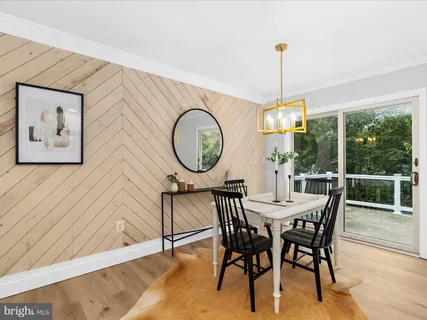a dining room with furniture a chandelier and a rug