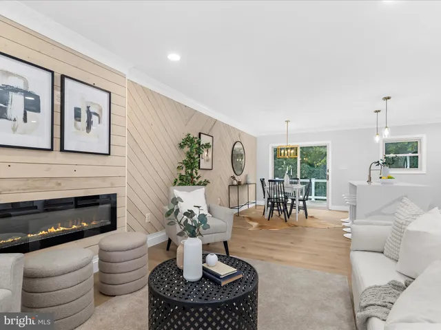 a living room with furniture a fireplace and a table