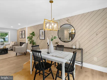 a dining room with furniture a rug and a chandelier