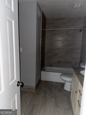 a bathroom with a toilet and a shower