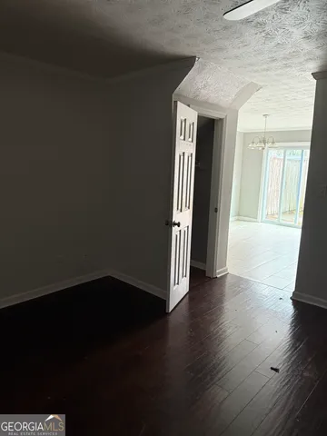 a view of a hallway with wooden floor and a fireplace