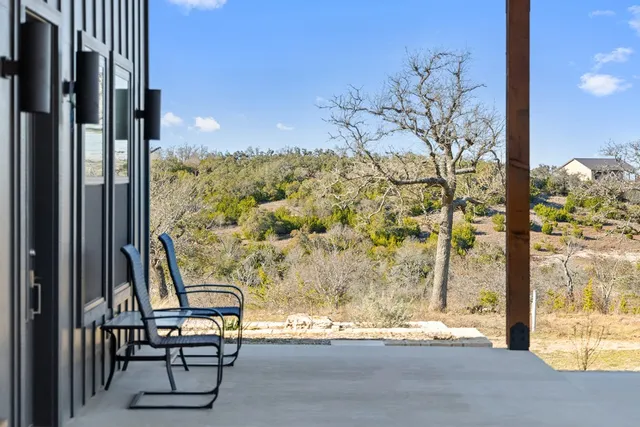 a view of a balcony with chair and table in the patio