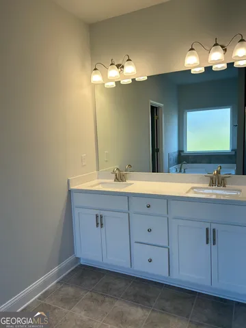 a bathroom with a double vanity sink and a mirror