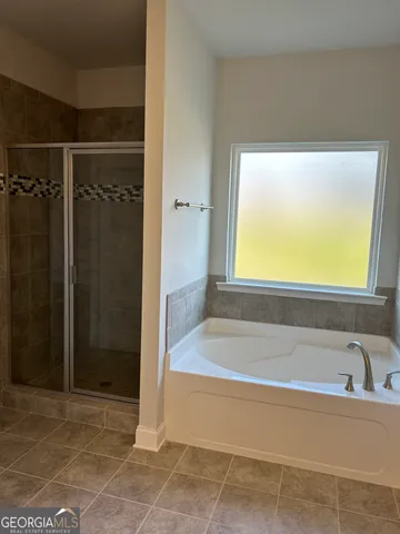 a bathroom with a bathtub and a shower