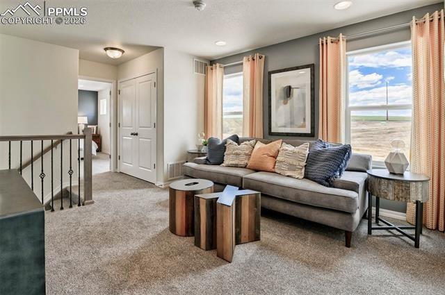5356 Truscott Road Colorado Springs, CO 80925 - Photo 12 of 16 a living room with furniture and a large window