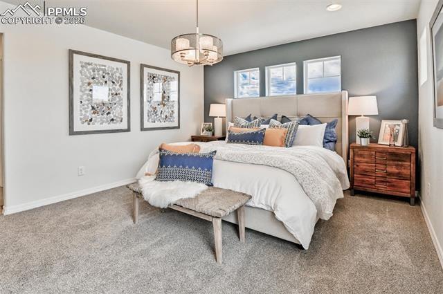 5356 Truscott Road Colorado Springs, CO 80925 - Photo 14 of 16 a bedroom with bed and window