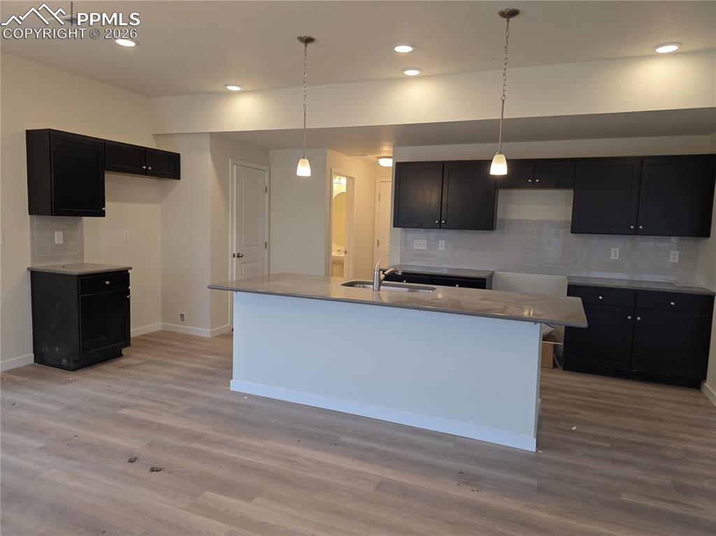 5356 Truscott Road Colorado Springs, CO 80925 - Photo 4 of 16 a kitchen with stainless steel appliances kitchen island granite countertop a stove a sink and a refrigerator