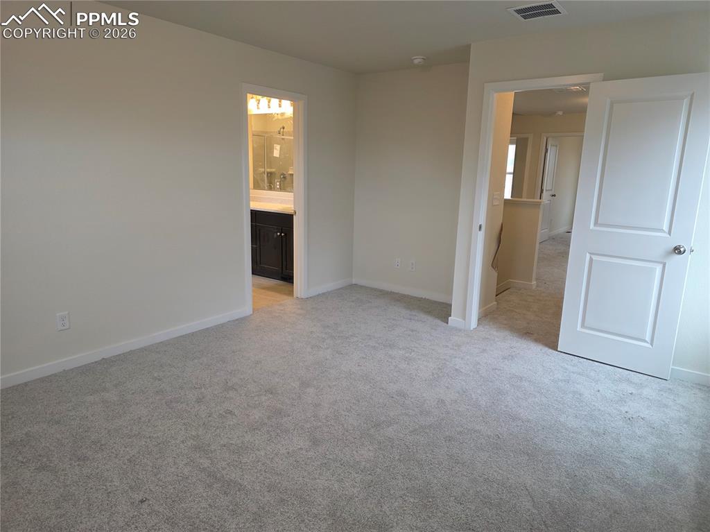 5356 Truscott Road Colorado Springs, CO 80925 - Photo 9 of 16 an empty room with windows and closet