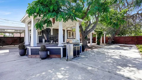 a view of a house with backyard and sitting area