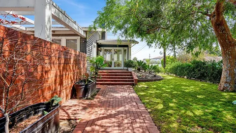 a view of a pathway of a house with wooden fence