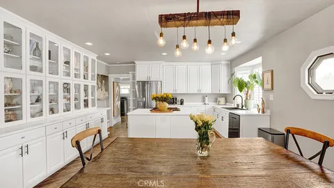 a living room filled with furniture and chandelier