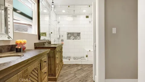 a bathroom with a sink double vanity and a shower