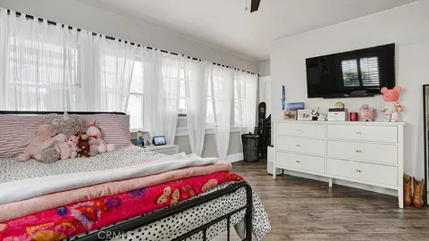 a bedroom with a bed and a flat screen tv