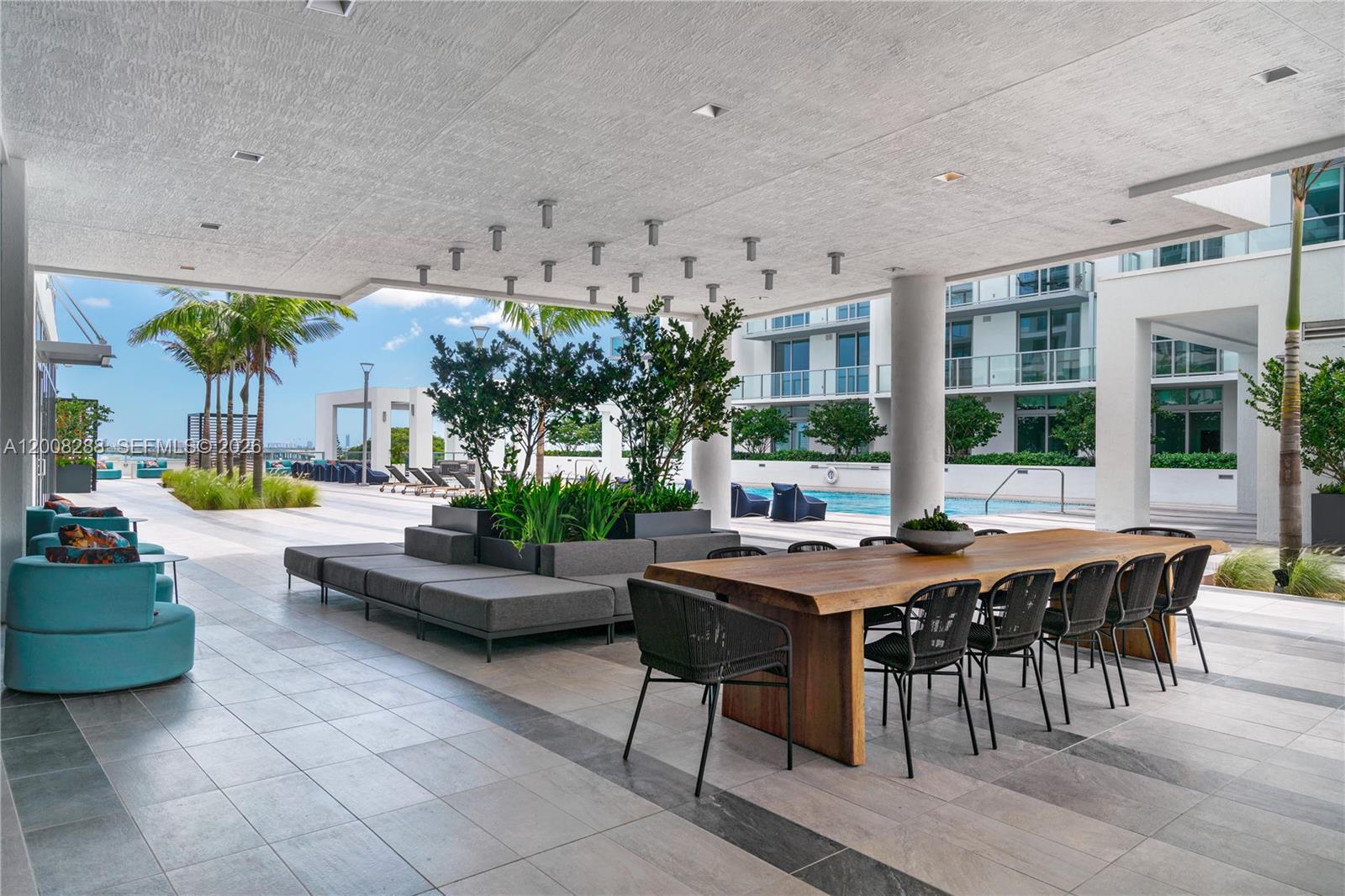 3900 Biscayne Boulevard, Unit S906 Miami, FL 33137 - Photo 15 of 17 a view of a patio with dining table and chairs