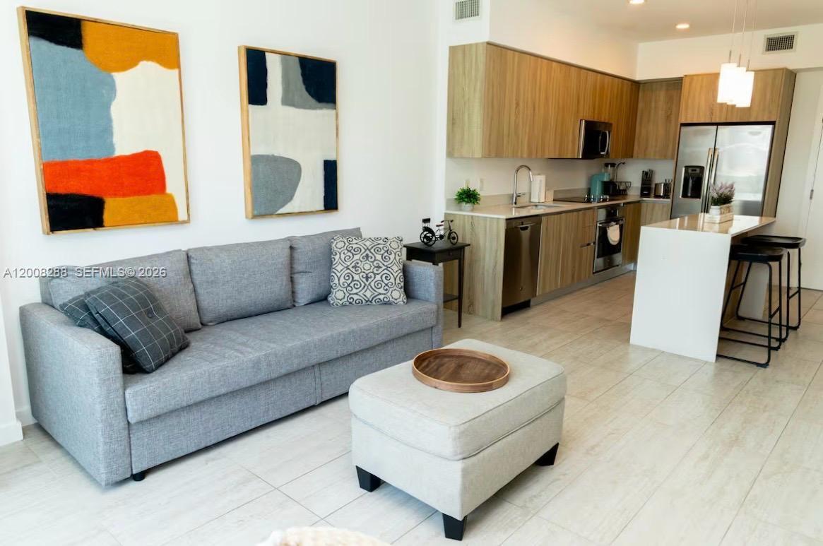 3900 Biscayne Boulevard, Unit S906 Miami, FL 33137 - Photo 4 of 17 a living room with furniture and a couch