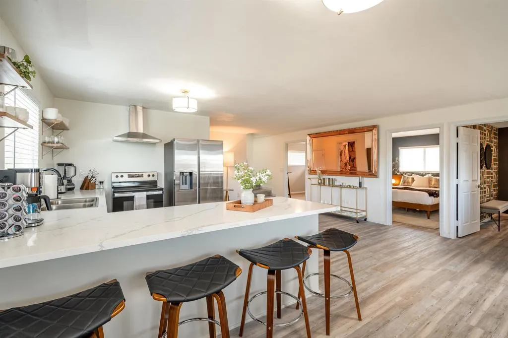 26086 Bear Valley Heights Road Valley Center, CA 92082 - Photo 13 of 65 a kitchen with sink and chairs