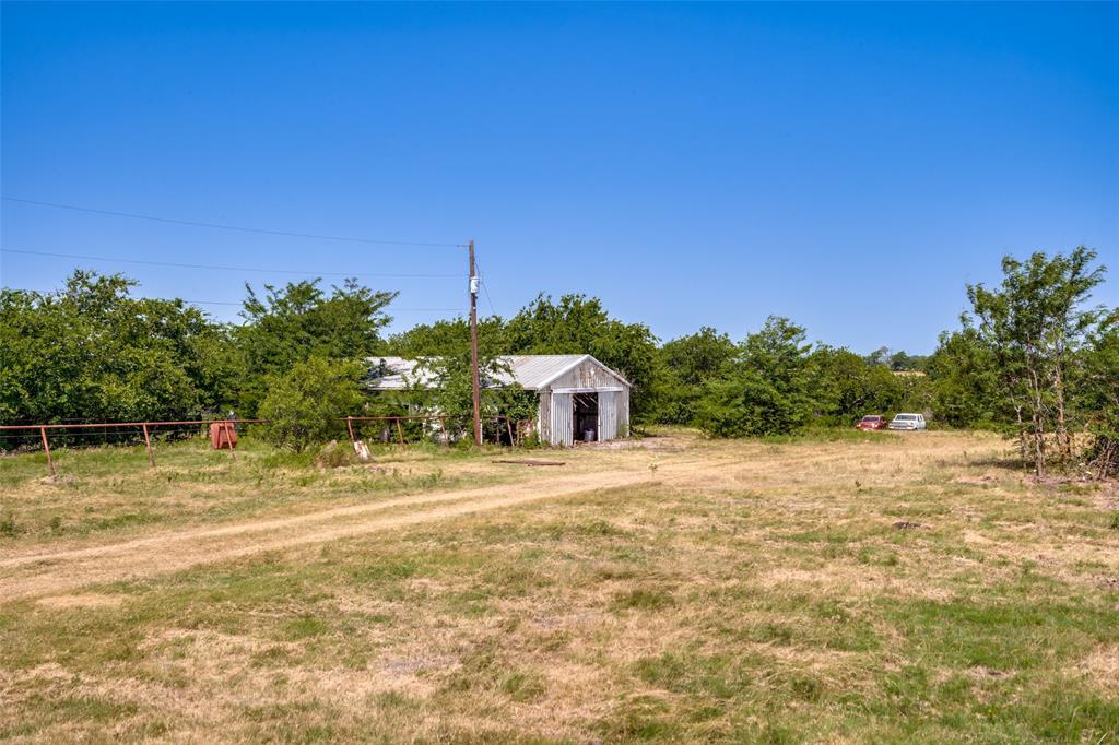 243 ROCK Court Decatur, TX 76234 - Photo 19 of 25 Expansive outdoor space featuring a dirt track and a metal outbuilding with an open doorway