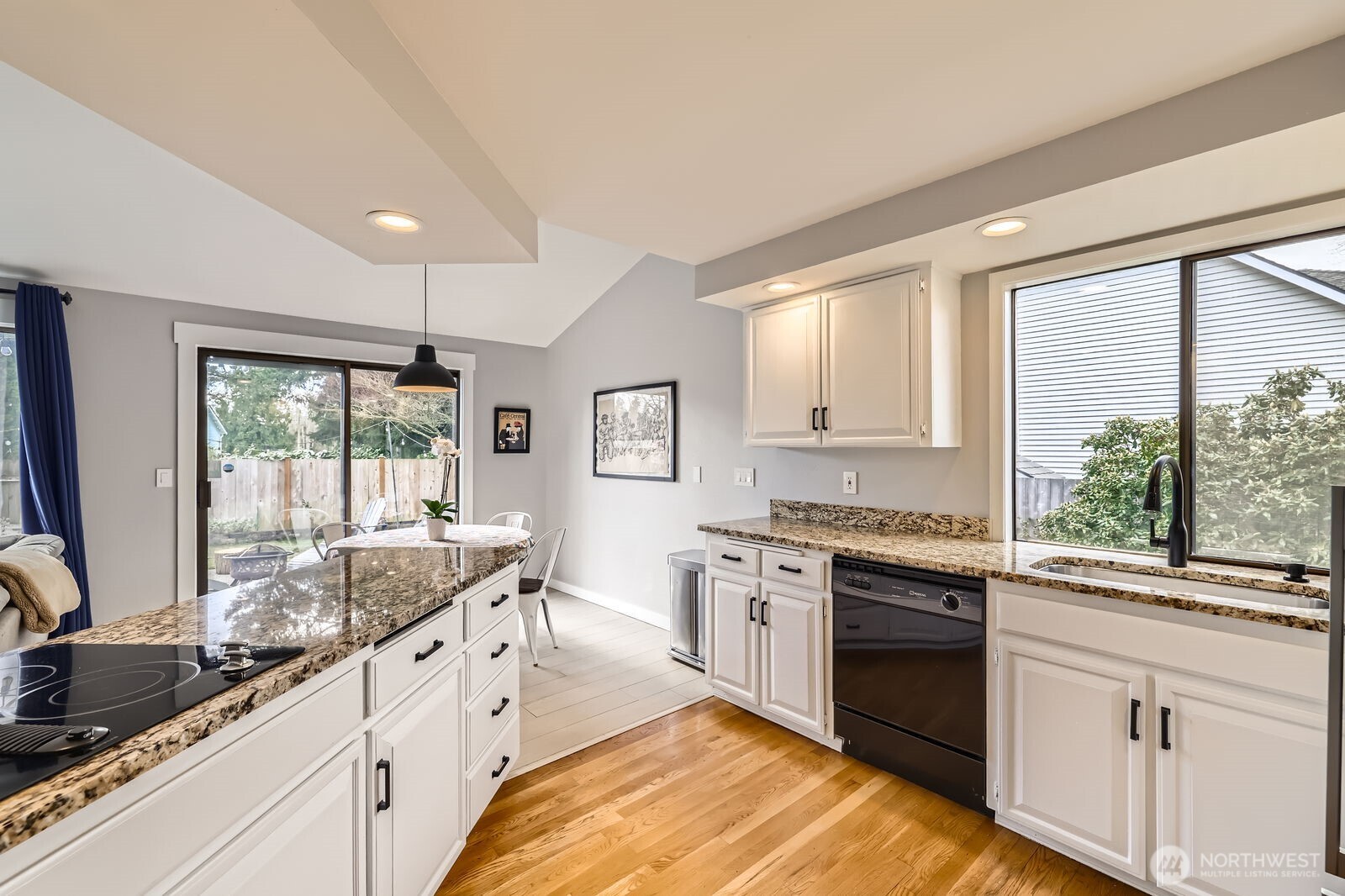 1608 243rd Place Southeast Bothell, WA 98021 - Photo 8 of 33 a large kitchen with kitchen island granite countertop a large window and white stainless steel appliances