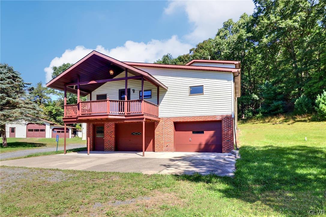 122 James Lane Stroudsburg, PA 18360 - Photo 2 of 50 a front view of a house with a yard and garage