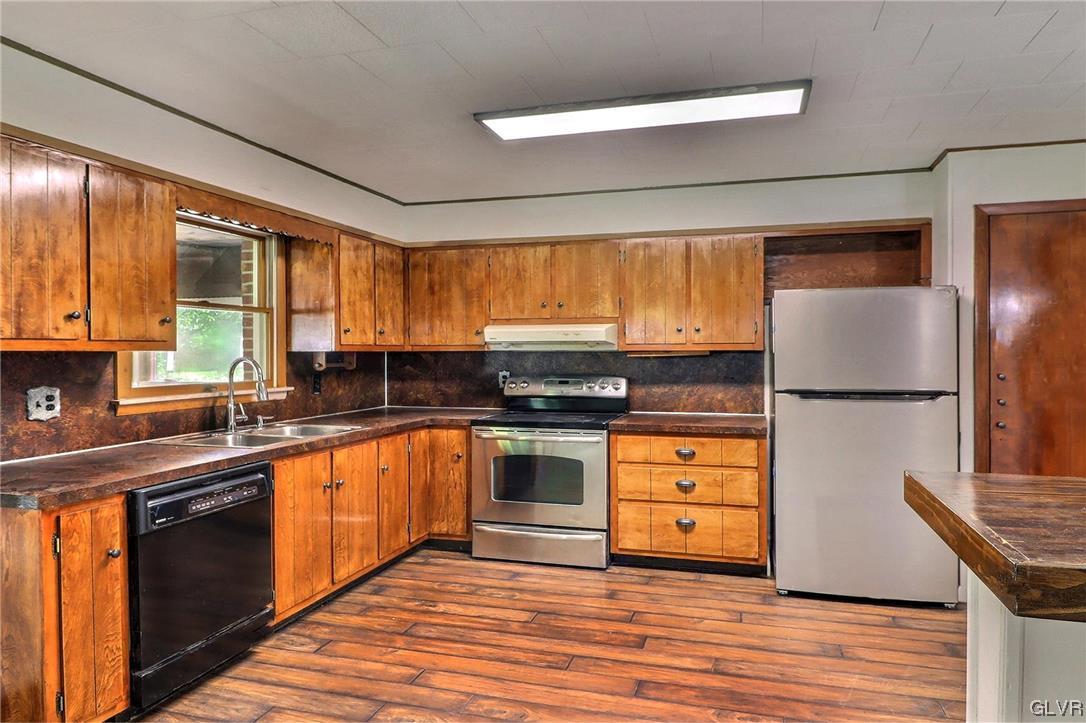 122 James Lane Stroudsburg, PA 18360 - Photo 3 of 50 a kitchen with stainless steel appliances granite countertop a refrigerator a sink dishwasher a stove and white countertops with wooden floor