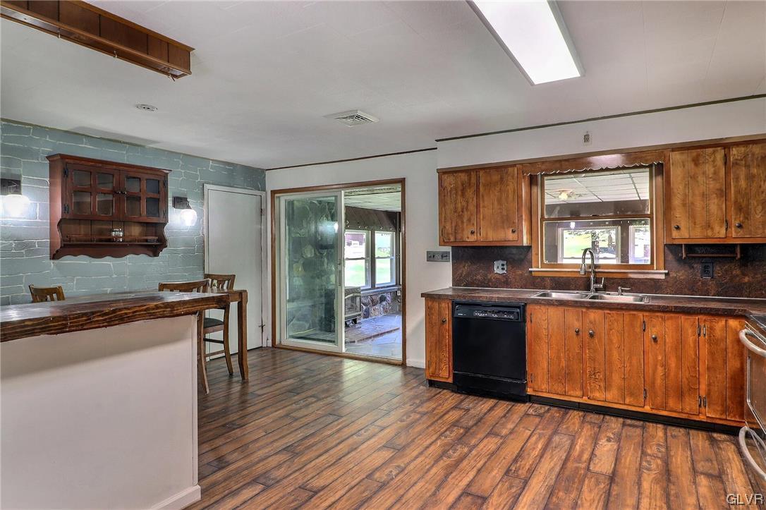 122 James Lane Stroudsburg, PA 18360 - Photo 4 of 50 a kitchen with stainless steel appliances granite countertop wooden cabinets sink and stove top oven