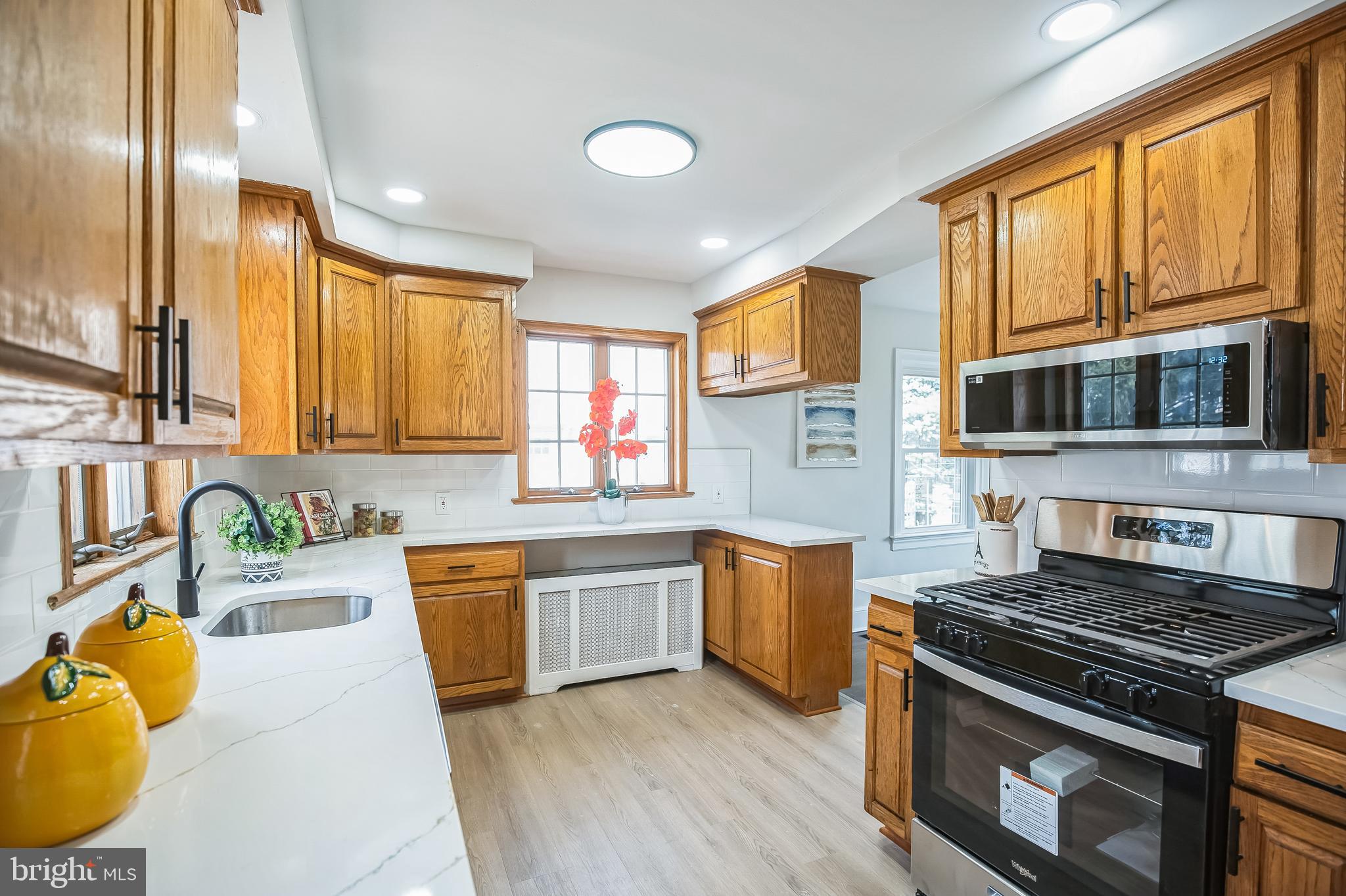 89 Reed Avenue Hamilton, NJ 08610 - Photo 11 of 30 a kitchen with stainless steel appliances granite countertop a stove and a sink