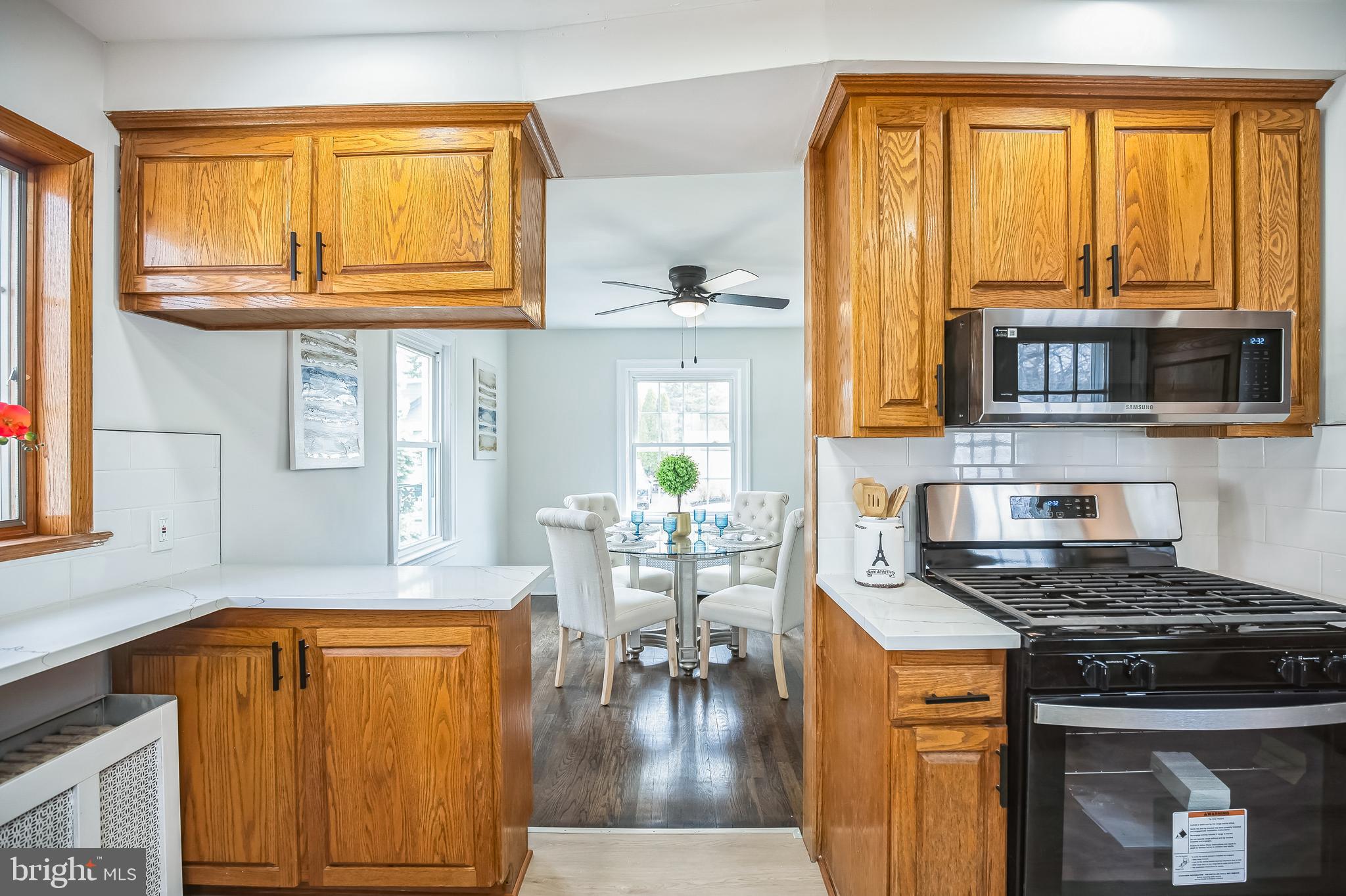 89 Reed Avenue Hamilton, NJ 08610 - Photo 12 of 30 a kitchen with stainless steel appliances granite countertop a stove and a microwave