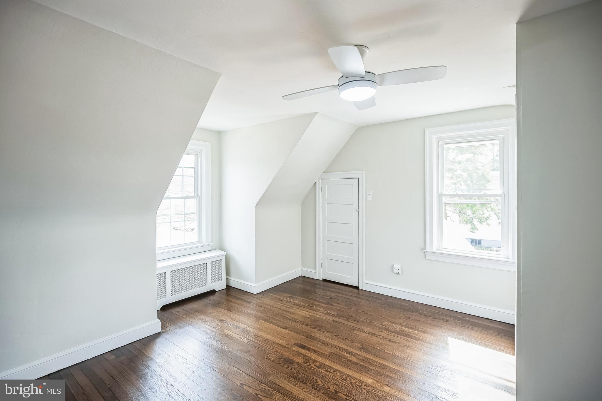 89 Reed Avenue Hamilton, NJ 08610 - Photo 21 of 30 an empty room with wooden floor fan and windows