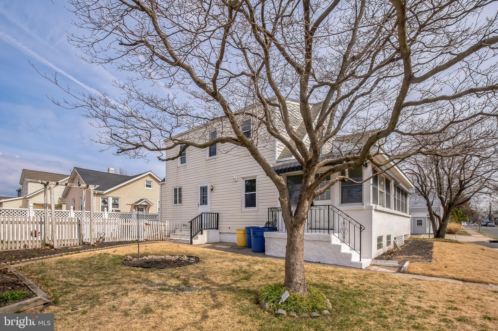 89 Reed Avenue Hamilton, NJ 08610 - Photo 29 of 30 a view of a white house with a large tree