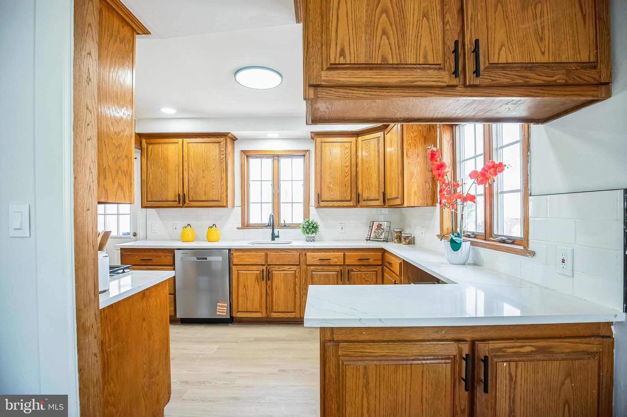 89 Reed Avenue Hamilton, NJ 08610 - Photo 7 of 30 a kitchen with stainless steel appliances granite countertop a sink and a stove