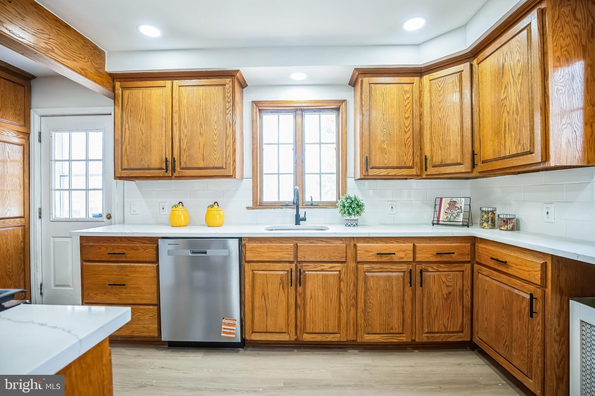 89 Reed Avenue Hamilton, NJ 08610 - Photo 8 of 30 a kitchen with stainless steel appliances granite countertop wooden cabinets a sink and a window