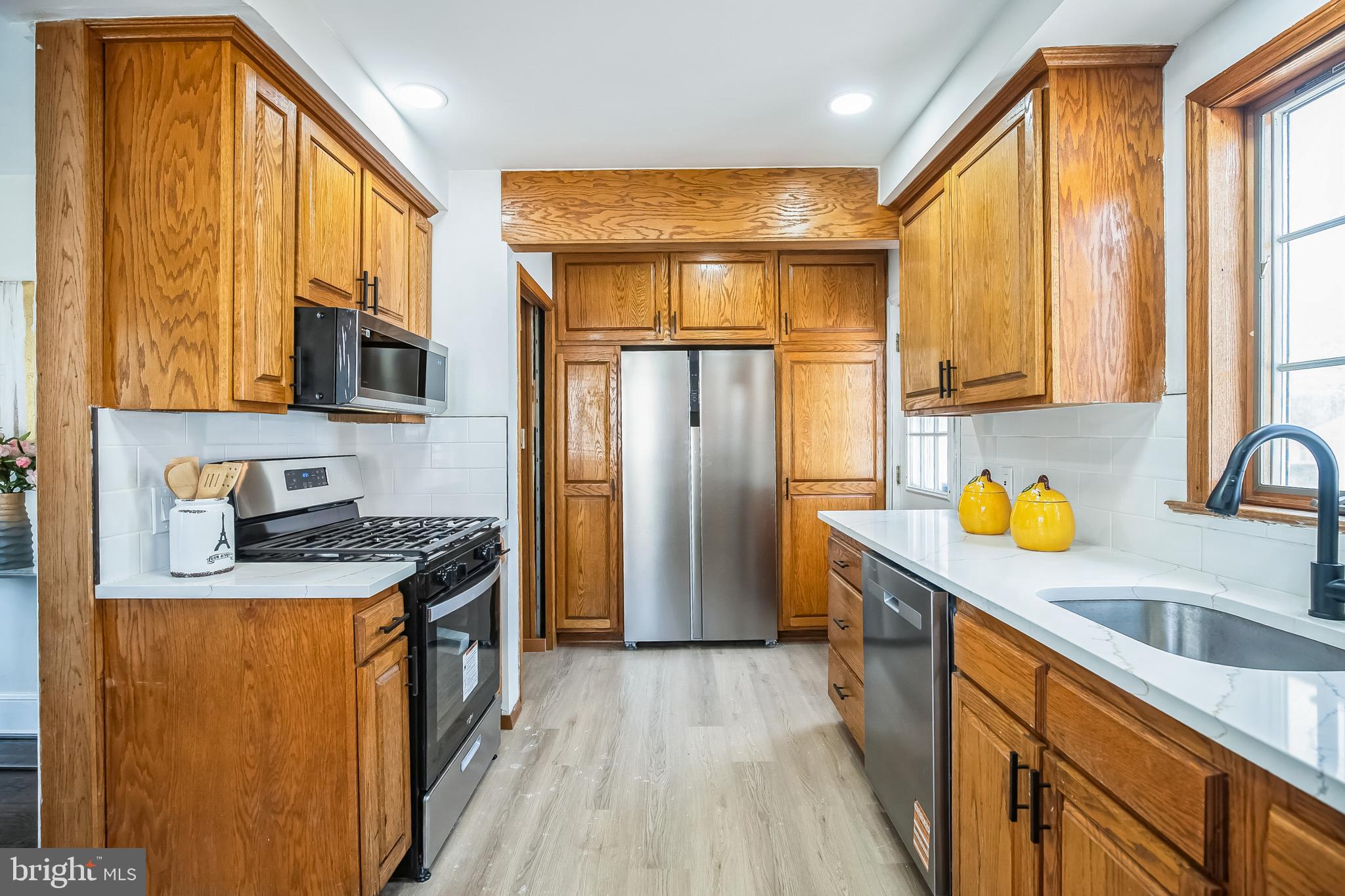 89 Reed Avenue Hamilton, NJ 08610 - Photo 10 of 30 a kitchen with stainless steel appliances granite countertop a sink stove and refrigerator