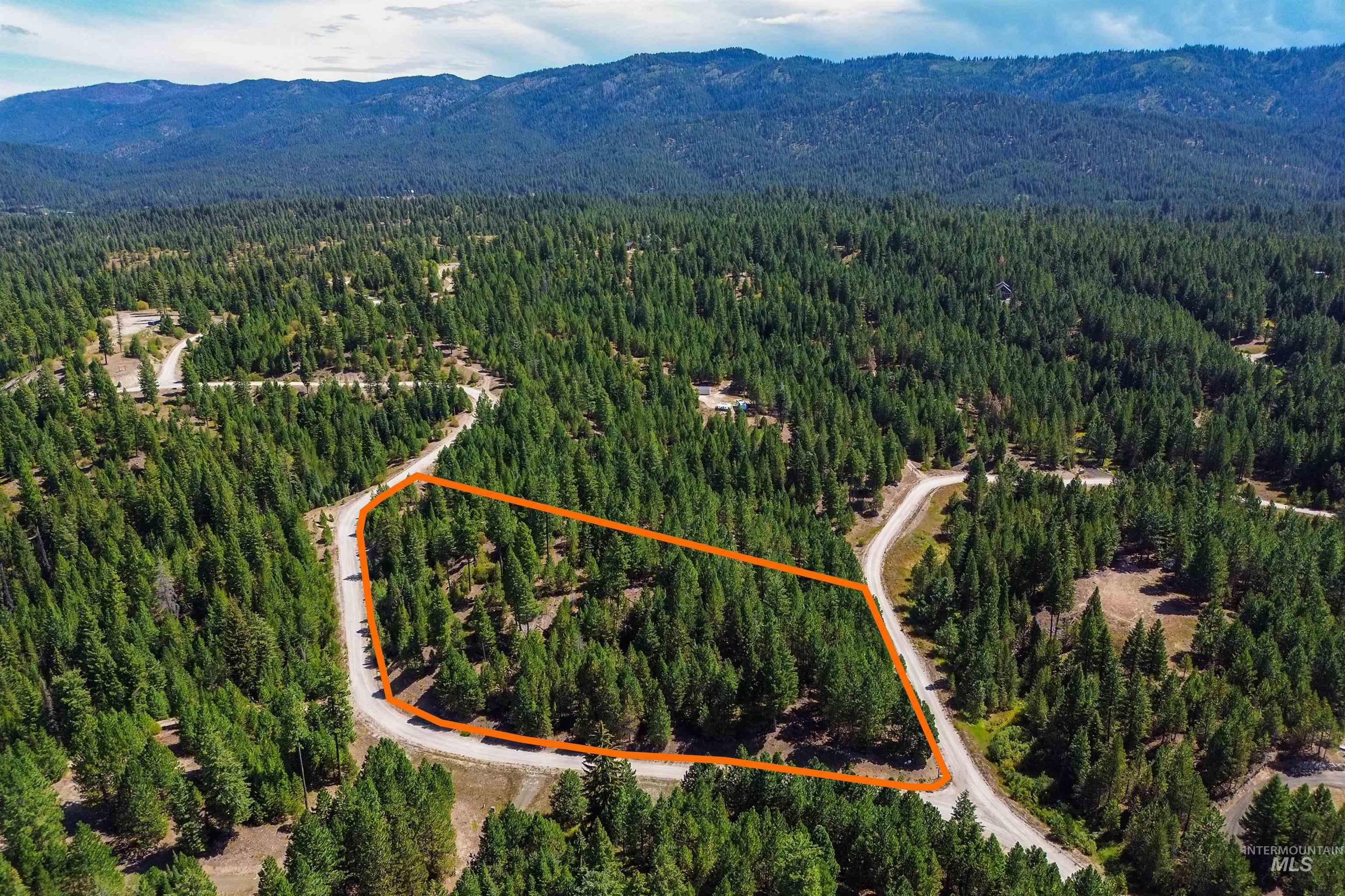 47 Coit Drive Cascade, ID 83611 - Photo 23 of 34 Aerial view of property and surrounding area with a mountainous background and property boundaries highlighted