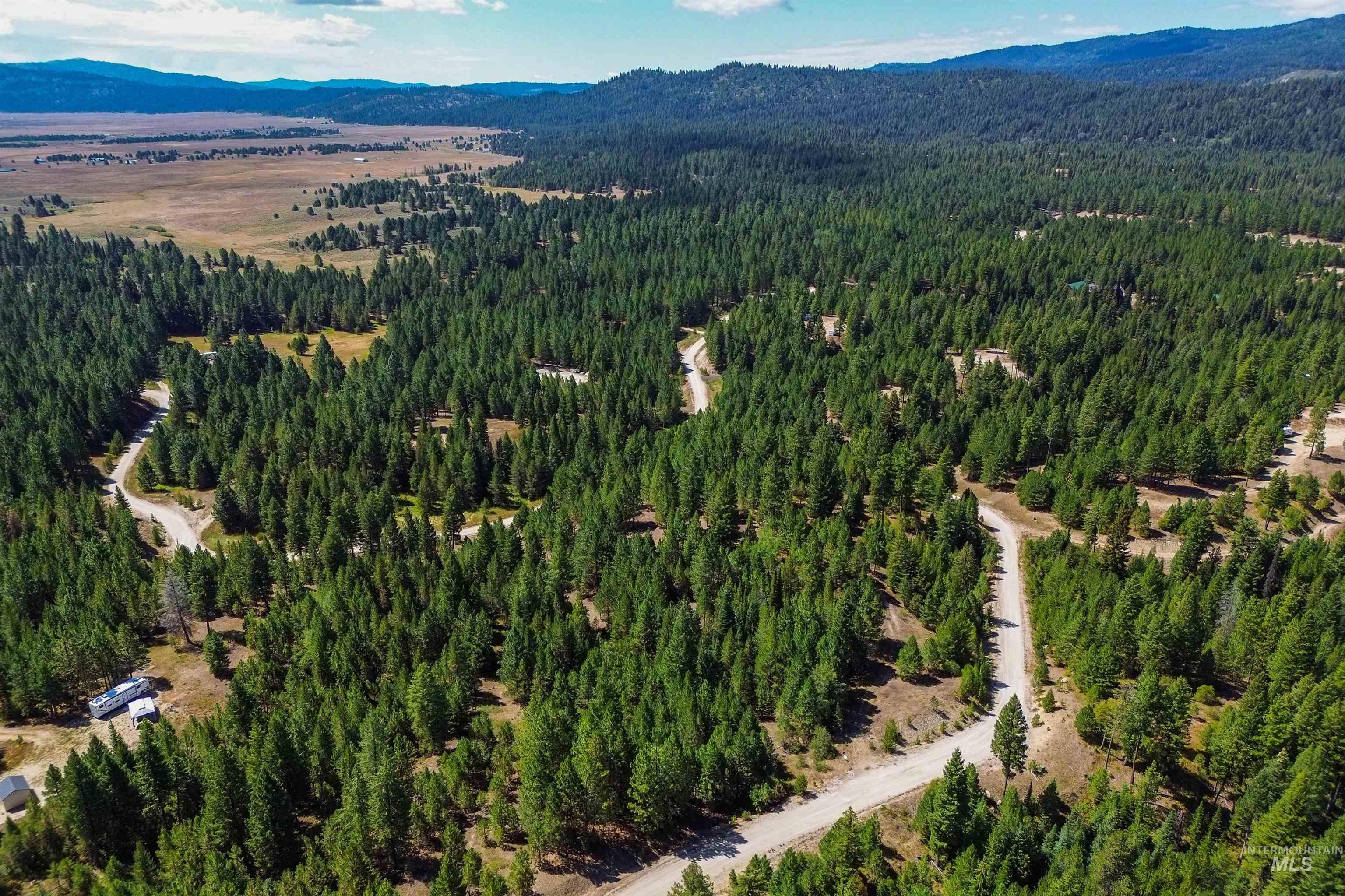 47 Coit Drive Cascade, ID 83611 - Photo 30 of 34 Aerial view of a mountain backdrop and a heavily wooded area
