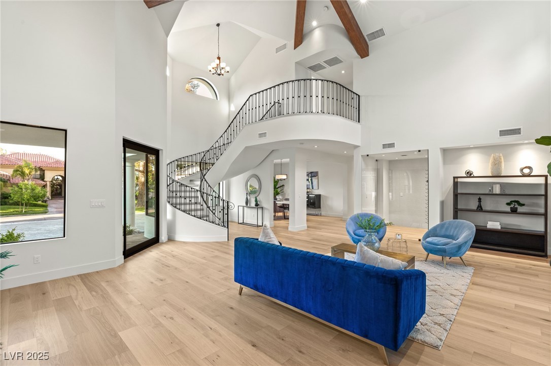2316 Prometheus Court Henderson, NV 89074 - Photo 5 of 92 Living area with wood finished floors, high vaulted ceiling, visible vents, and stairs