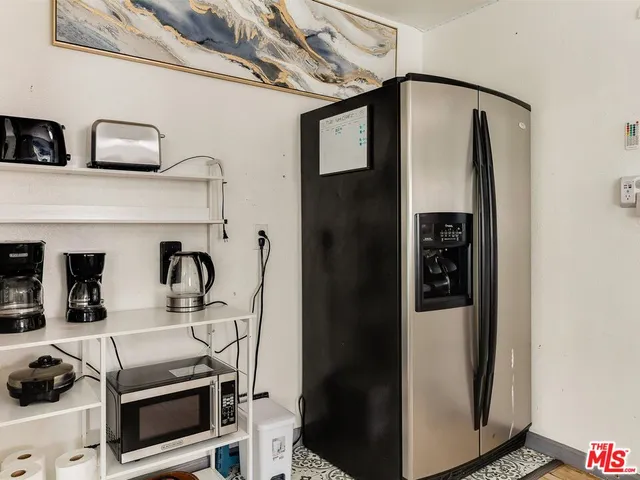 a kitchen with stainless steel appliances granite countertop a refrigerator and a stove
