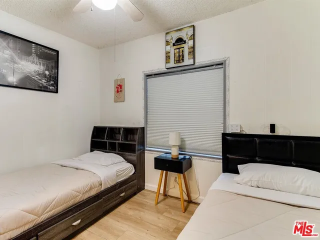 a bedroom with a bed and a night stand