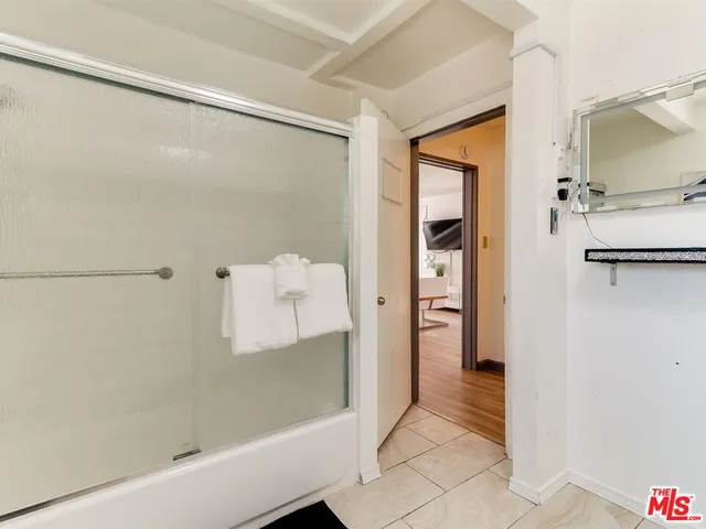 a bathroom with a shower and a sink