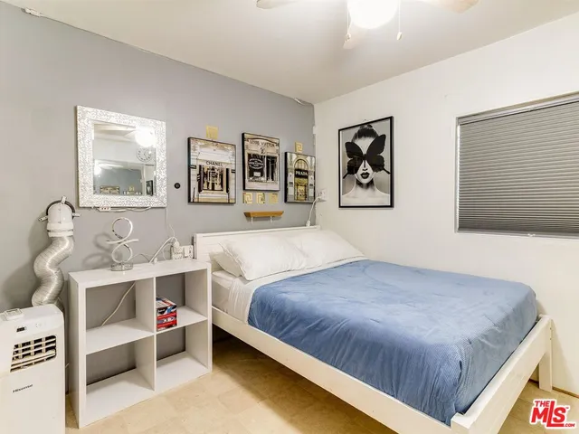 a bedroom with a bed and wall painting