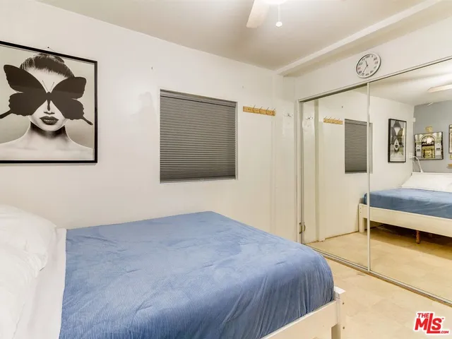 a bedroom with a bed and wall painting