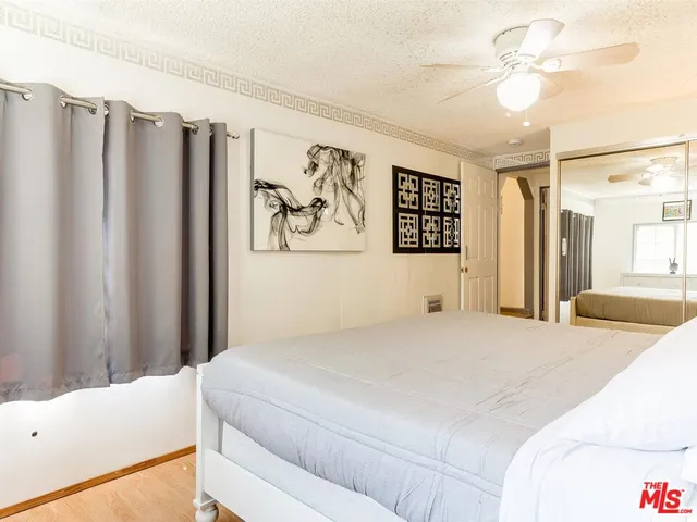 a bedroom with a large bed and a chandelier