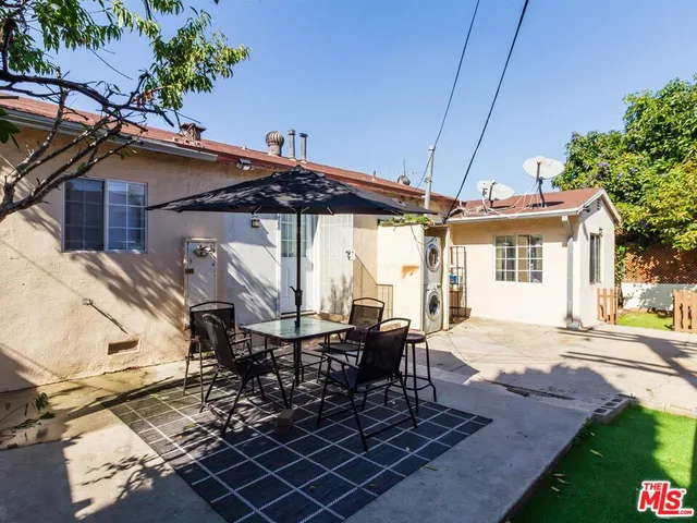 a patio with sofas table and chairs